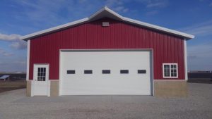 A barn style building with a white garage door